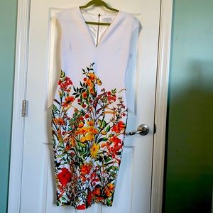 White dress with flowers print v neck back zipper.